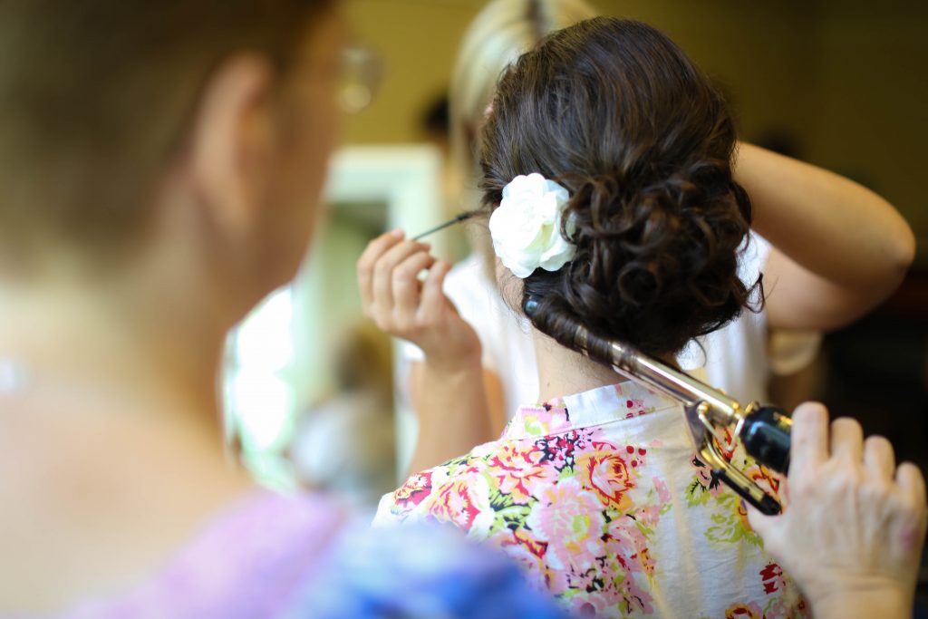 woman getting bridal hair work done by Gainesville Wedding Hair